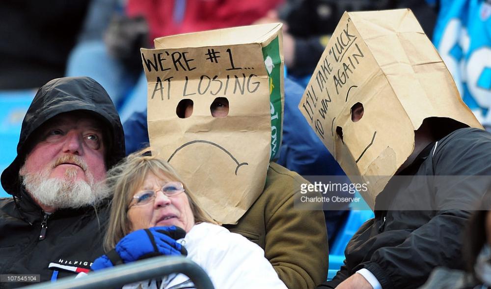 two-panthers-fans-wear-paper-bags-over-their-heads-during-action-of-picture-id107545104.jpg